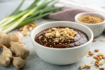 sauces asiatiques maison dans un bol blanc avec garniture fraîche sur fond granit